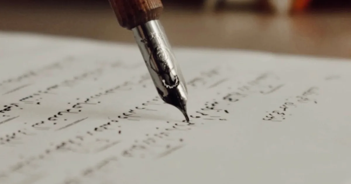 Schreibfeder auf handschriftlich beschriebenem Papier – Erbschein beantragen und Unterlagen vorbereiten